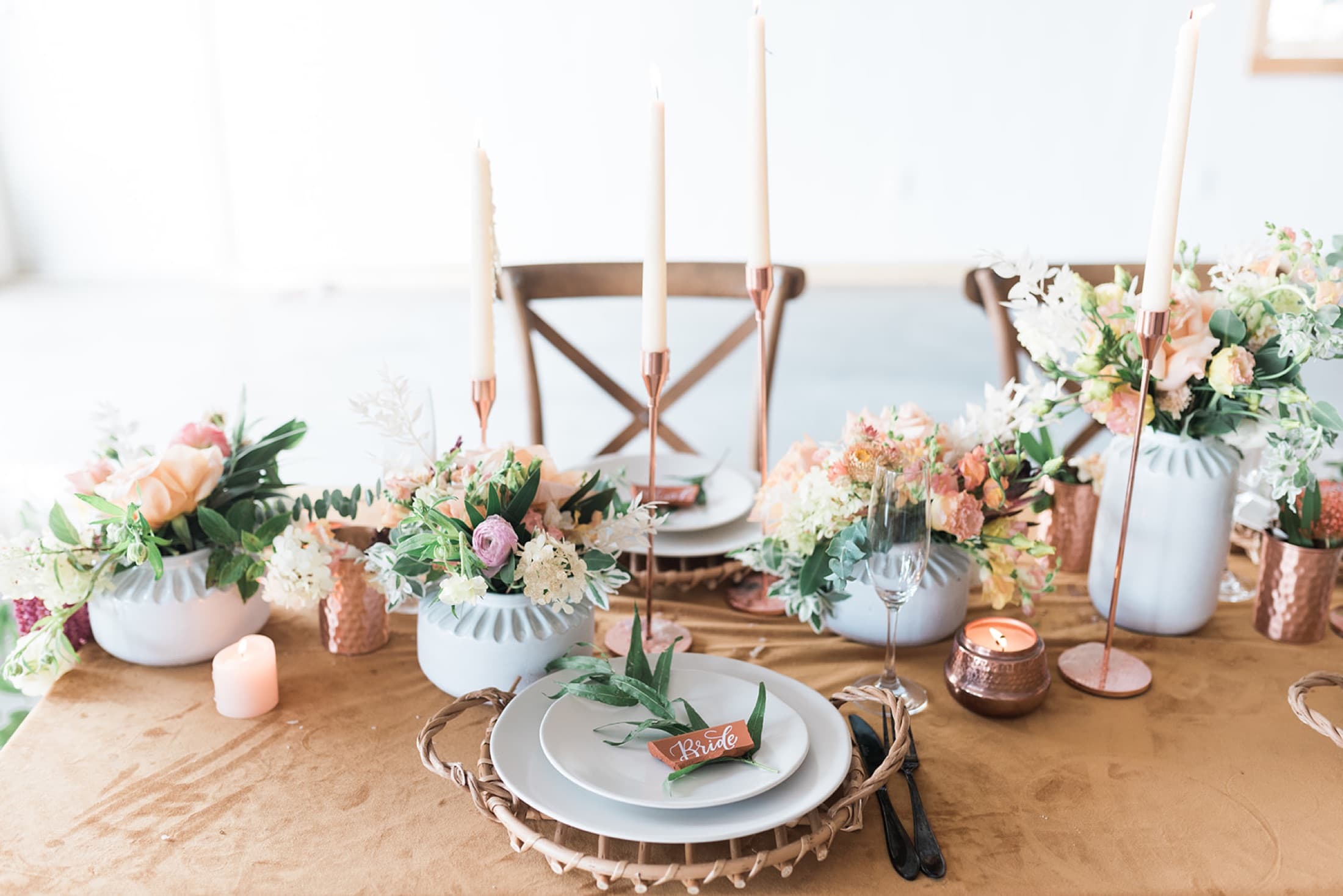 Wedding tablescape with florals and copper candlesticks